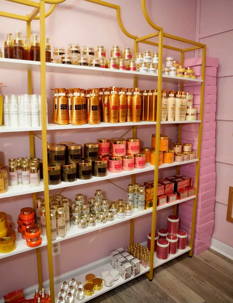Golden Glow by Mika products displayed on gold shelving in the Shreveport boutique
